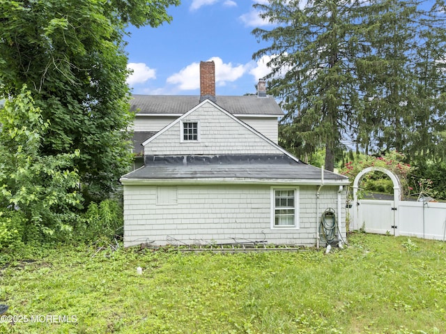 14 S Holmdel Rd, Holmdel, NJ 07733 - view of side of home featuring a chimney and a gate
