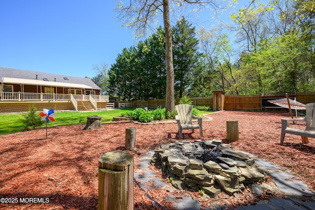 3297 Ridgeway Rd, Manchester, NJ 08759 - view of yard featuring stairway, a deck, a fenced backyard, and an outdoor fire pit