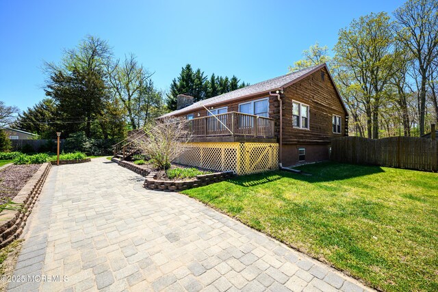 3297 Ridgeway Rd, Manchester, NJ 08759 - view of side of home featuring fence, log siding, a lawn, and a deck