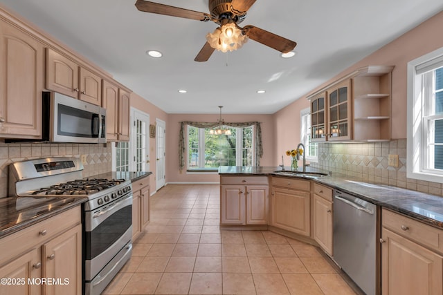 kitchen with stainless steel appliances, plenty of natural light, a sink, and light brown cabinets
