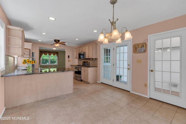 kitchen featuring tasteful backsplash, open shelves, ceiling fan with notable chandelier, a peninsula, and stainless steel appliances