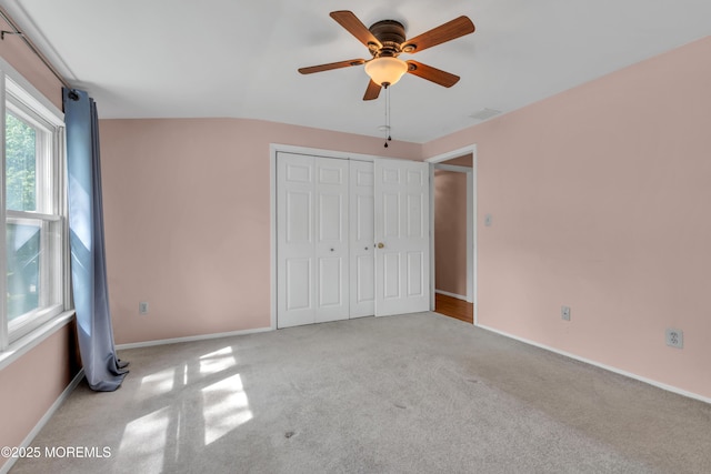 unfurnished bedroom featuring a closet, carpet flooring, and baseboards