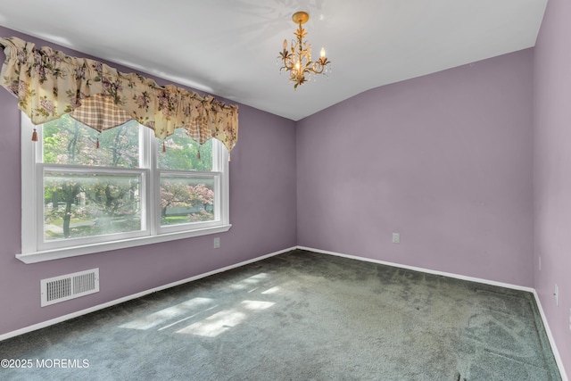 spare room with carpet floors, baseboards, visible vents, and an inviting chandelier