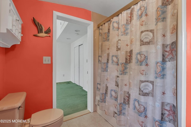 full bathroom with toilet and tile patterned flooring