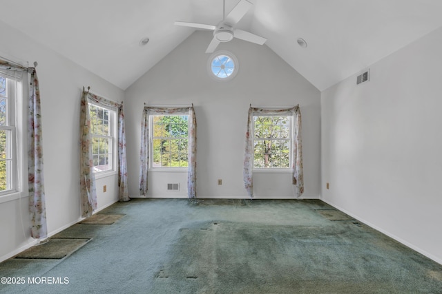 spare room featuring plenty of natural light, carpet flooring, ceiling fan, and visible vents