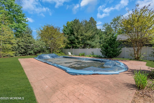 view of pool featuring a fenced in pool, a fenced backyard, a patio area, and a yard