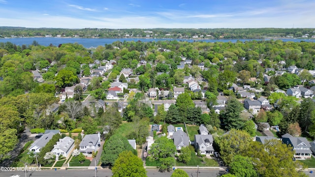 birds eye view of property with a water view and a residential view