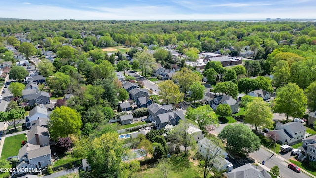 birds eye view of property featuring a forest view and a residential view