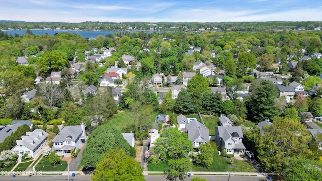 drone / aerial view with a water view and a residential view
