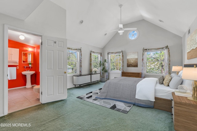 bedroom featuring connected bathroom, a sink, high vaulted ceiling, carpet, and visible vents