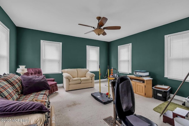 office with baseboards, light colored carpet, and a ceiling fan