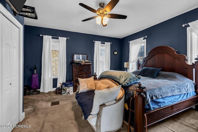 bedroom featuring ceiling fan, visible vents, and carpet floors