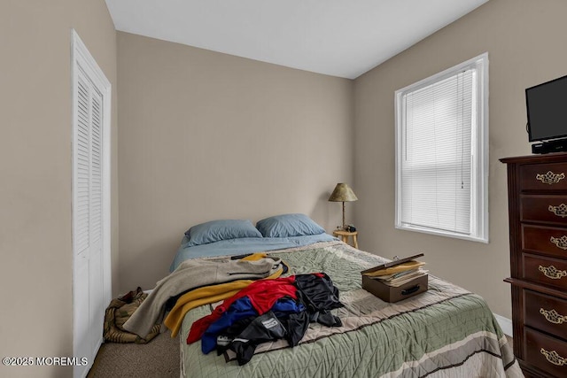 carpeted bedroom with a closet