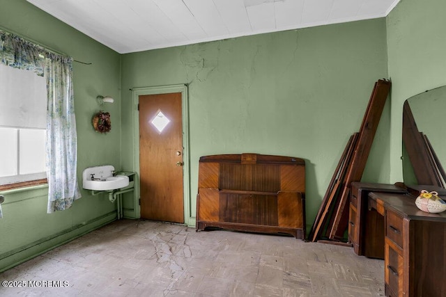 interior space featuring a baseboard heating unit and a sink