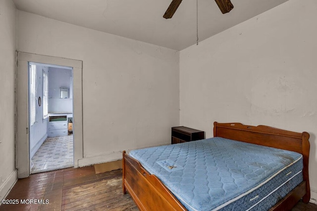 bedroom featuring ceiling fan, wood-type flooring, and baseboards