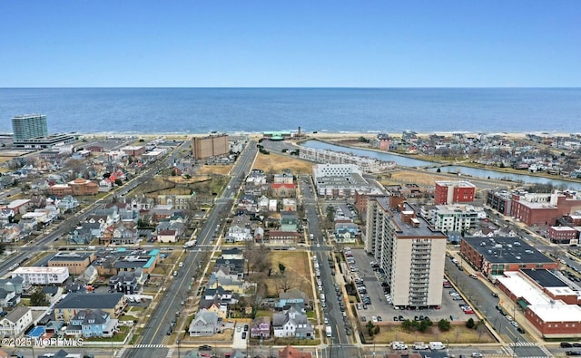 birds eye view of property with a water view and a view of city