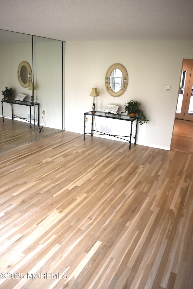 empty room featuring wood finished floors and a wealth of natural light