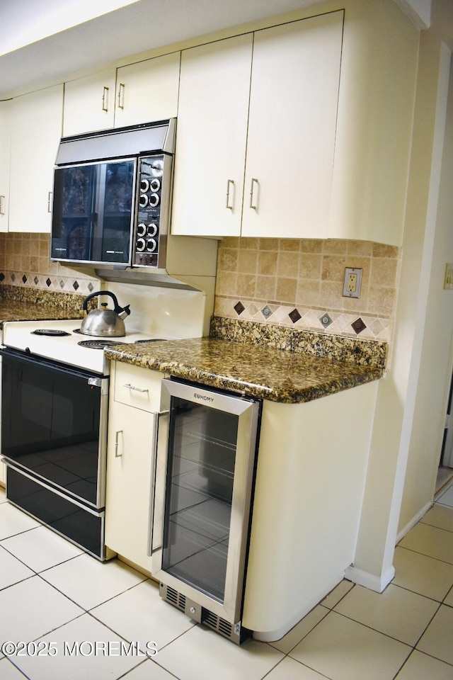 kitchen featuring wine cooler, decorative backsplash, electric range oven, and white cabinets