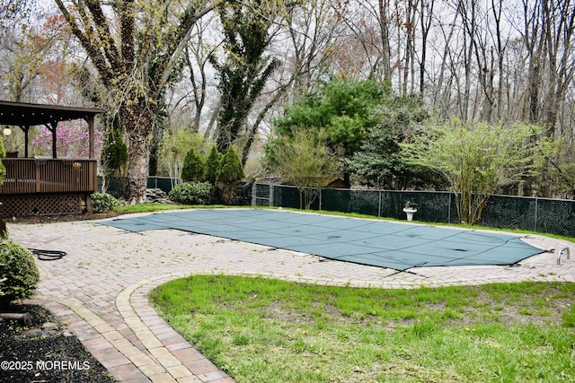 view of pool featuring a patio area, fence, a fenced in pool, and a lawn