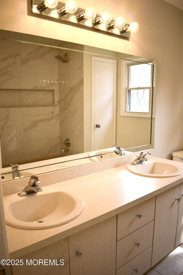 full bath with a sink, walk in shower, and double vanity