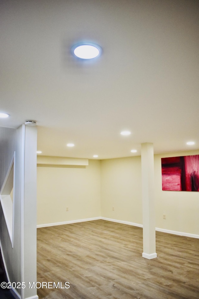 finished basement featuring baseboards, recessed lighting, and wood finished floors