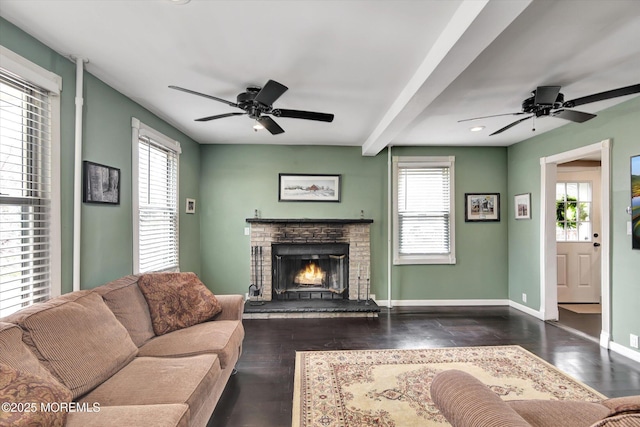 living room featuring ceiling fan and plenty of natural light