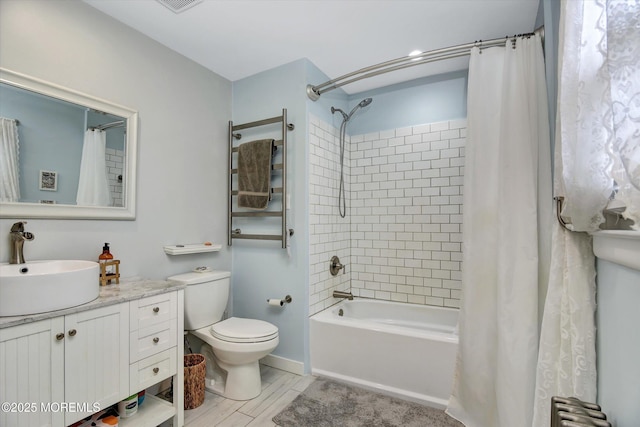 bathroom with vanity, toilet, visible vents, radiator, and shower / bath combo with shower curtain