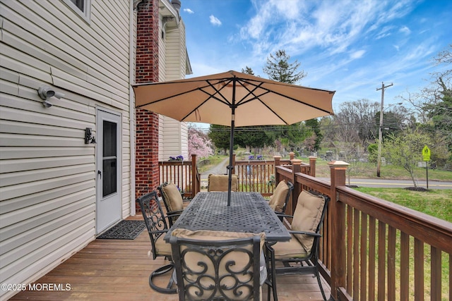 wooden deck featuring outdoor dining area