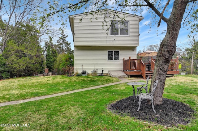 rear view of property with a deck and a lawn