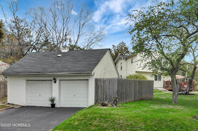 detached garage featuring fence