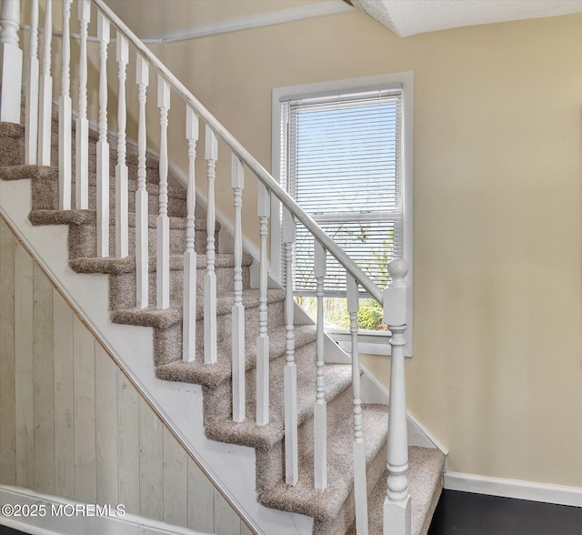 staircase featuring baseboards