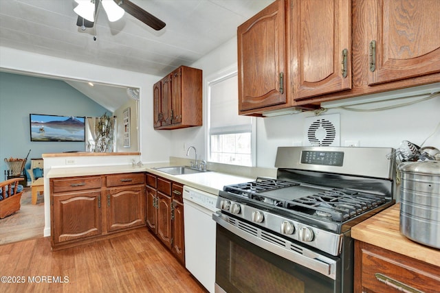 274 Prospect Ave, Old Bridge, NJ 08857 - kitchen featuring stainless steel gas range oven, white dishwasher, light wood-style floors, ceiling fan, and brown cabinetry