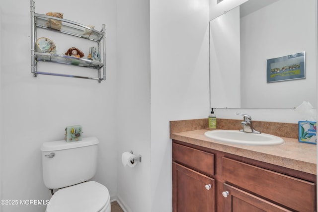 half bathroom featuring toilet and vanity