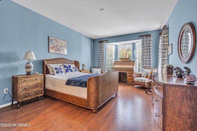 bedroom with dark wood-style floors