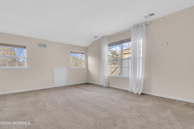 empty room with baseboards, visible vents, and carpet floors