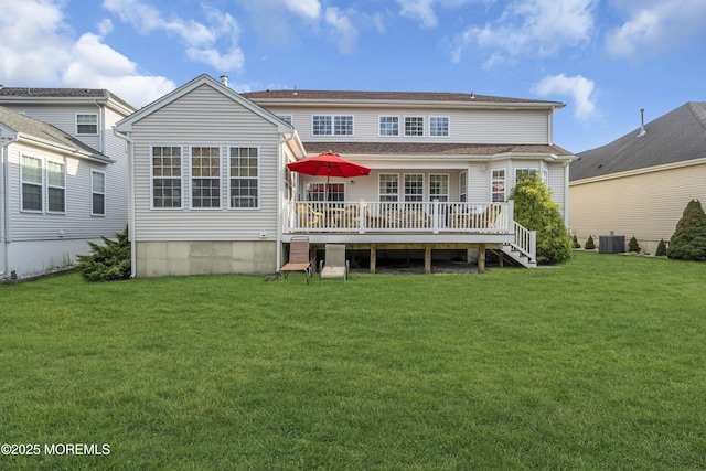 back of property featuring a deck, a lawn, and cooling unit