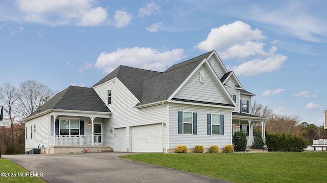 view of front of house with central air condition unit, a front lawn, driveway, a shingled roof, and a porch
