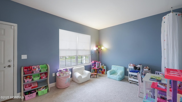 rec room with baseboards and carpet
