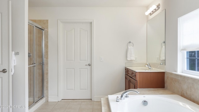 bathroom with a garden tub, tile patterned floors, a stall shower, and vanity