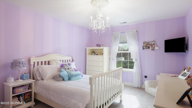 carpeted bedroom with visible vents, baseboards, and a notable chandelier