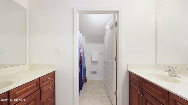 bathroom with two vanities, tile patterned flooring, a sink, and visible vents