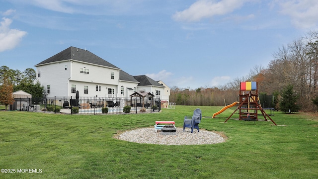 rear view of house featuring a patio area, fence, a yard, and a playground