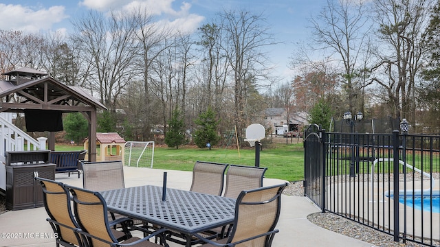 view of patio / terrace featuring fence, outdoor dining area, a fenced in pool, and a gazebo