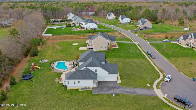 birds eye view of property featuring a residential view and a wooded view