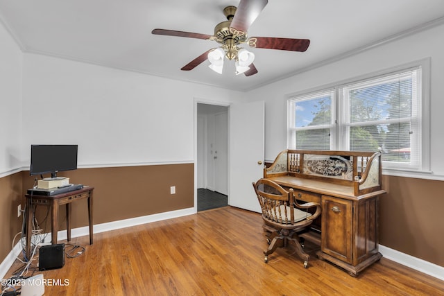 office space featuring ceiling fan, baseboards, ornamental molding, and wood finished floors