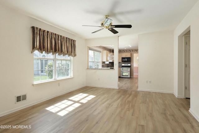 unfurnished living room featuring light wood-style floors, baseboards, ceiling fan, and visible vents