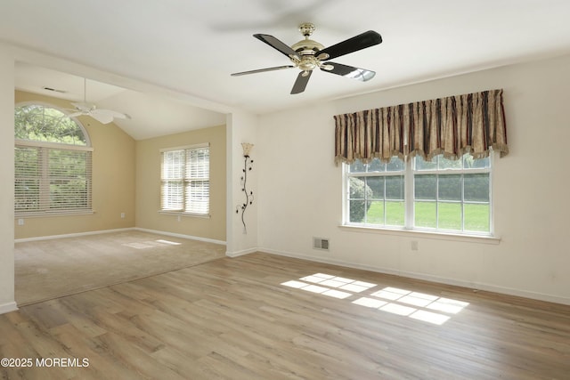 unfurnished room with light wood-style floors, baseboards, ceiling fan, and visible vents