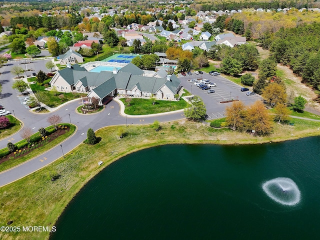 birds eye view of property with a water view and a residential view