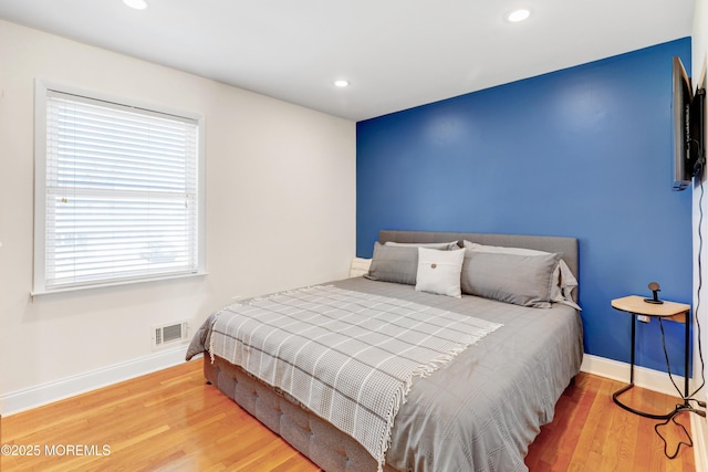 bedroom featuring recessed lighting, wood finished floors, visible vents, and baseboards