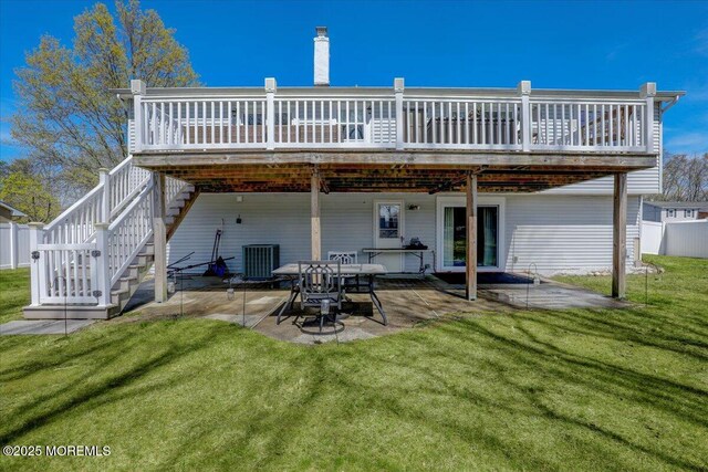 back of property with a lawn, stairs, a deck, and a patio